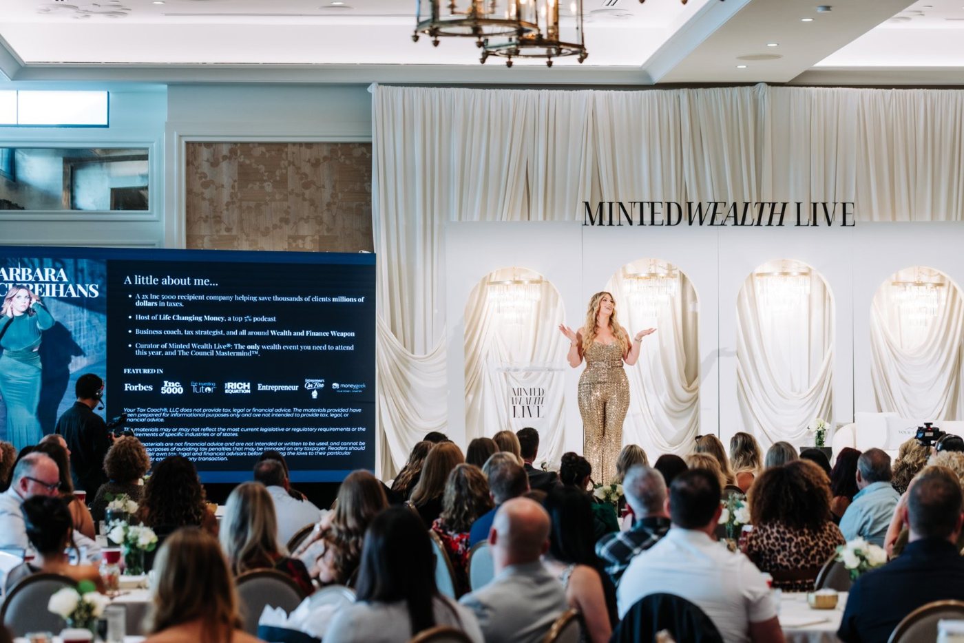 Barbara on stage in front of a full room